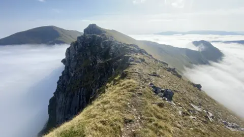 John Stokes A rocky mountain ridge during cloud inversion

