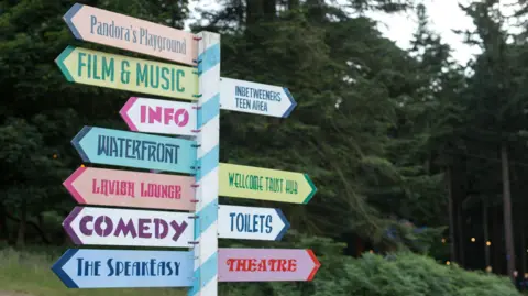A colourful sign with words such as COMEDY and THEATRE written on it.