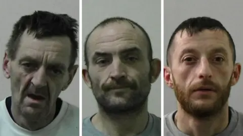 Northumbria Police Mugshots of Royal, Patterson and Curley. Royal looks dishevelled with a craggy face and messy dark hair. Patterson has close cropped dark hair and a beard with a cut on the top of his head. Curley has a ginger beard and short dark hair.