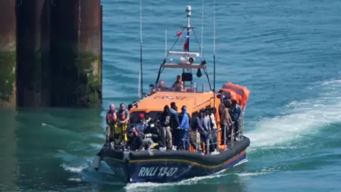 A group of people thought to be migrants are brought in to Dover, Kent, onboard an RNLI Lifeboat
