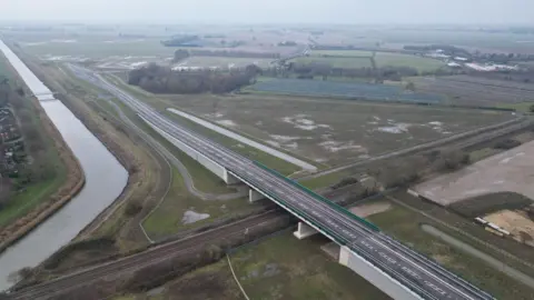 A drone picture of a new road and bridge, the road ends suddenly