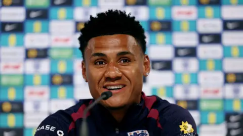 Reuters Ollie Watkins speaks into a microphone during a press conference