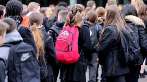 Getty Images Pupils at St Paul's High School in Glasgow. A general view of high school pupils in the playground of the school, waiting to start the day.
