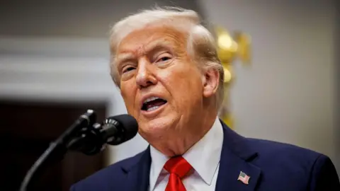 Getty Images Donald Trump wearing a blue suit talking 