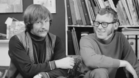 Radio Times via Getty Images A black and white photo of the future Goodies Bill Oddie and Graeme Garden in 1973
