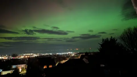 Denise Casey Green skies above a landscape of twinkling lights in Prestatyn, North Wales.