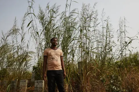 Hugh Kinsella Cunningham Mohammed Kanu, a former frontline worker during the Ebola crisis at Waterloo Ebola Graveyard. Sierra Leone.