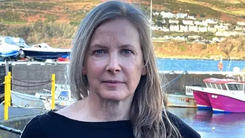 BBC Rosalind Ranson standing on the waterfront