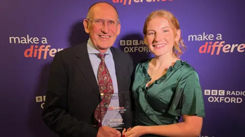 Richard Wicks stood with his make a difference award alongside his daughter