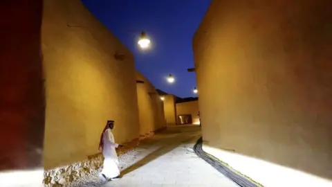 Reuters A Saudi man walks past renovated buildings at the historic city of Diriyah