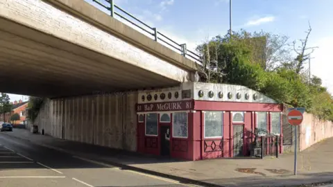 Google Maps A memorial is painted on the motorway flyover where McGurk's bar used to stand