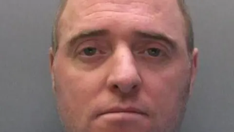 Cleveland Police A close up mugshot of Ray McDonald who is a man in his fifties, clean-shaven with a receding hair line 