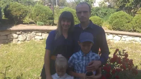 Sergey Ilkun Sergey and his family in a garden