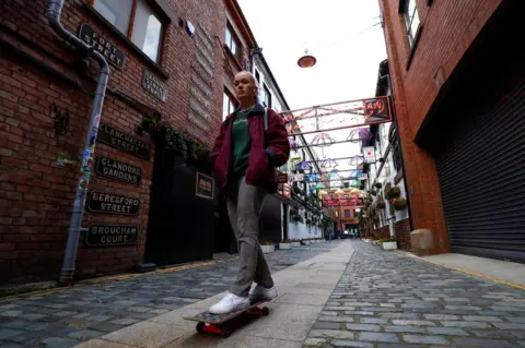 Reuters A young woman on a skateboard on a Belfast street