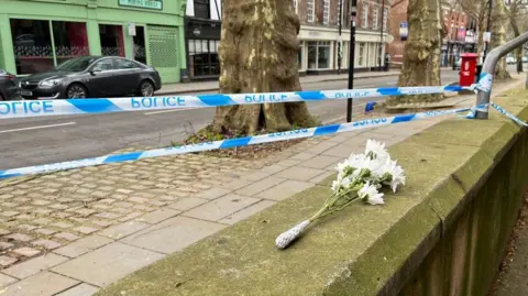 Flowers have been left at the scene in Friar Gate, Derby, on Sunday 29 March 2026.
