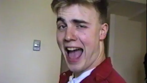 Take That/Netflix This close-up image of Gary Barlow shows him with his mouth wide open as he stares directly at the camera. 