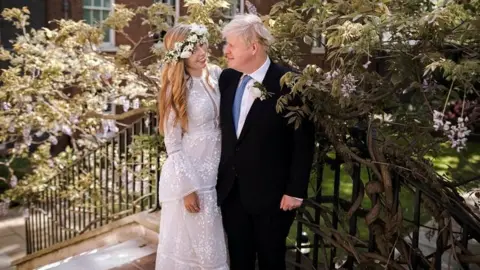 PA Media Boris and Carrie Johnson after their wedding in May