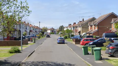 Google A Google Street image of a quiet, residential street.