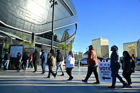 Frederic J Brown/AFP People line up to vote at a polling station at Allegiant Stadium in Las Vegas, Nevada, on Election Day, 5 November 2024 
