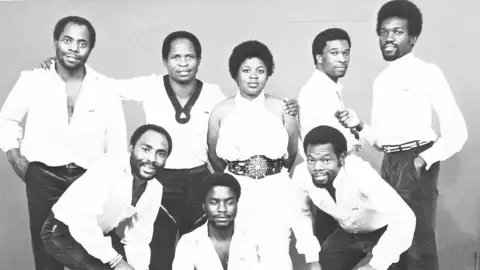 Now-Again Records WITCH's members pose for a group photo, printed in black and white.