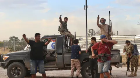 Getty Images Members of Libyan army celebrate after recapturing Tripoli airport from warlord Khalifa Haftar's militias in Tripoli, Libya on June 03, 2020.