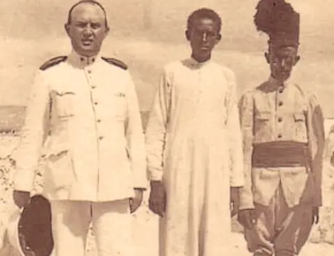 Razza Partigiana/Family archive Giuseppe Marincola (L) pictured in Somalia with two Somalis