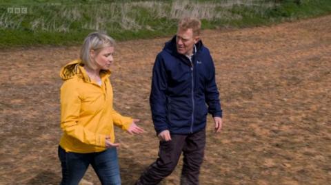 Sarah Keith-Lucas and Adam Henson in a bare field