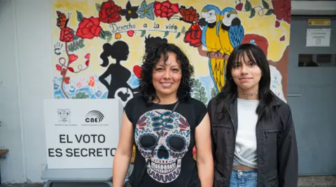 After voting in Ecuador election, Fernanda Iza (left) poses for a picture