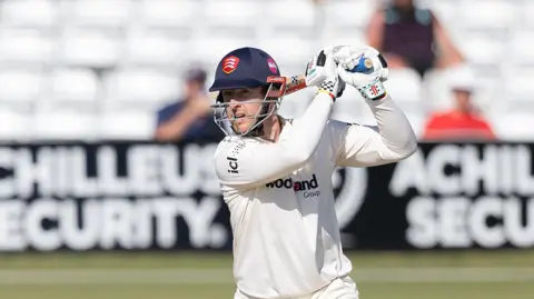Essex's Simon Harmer drives through the covers for four against Hampshire