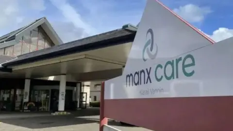 A picture of a Manx Care sign infront of a building