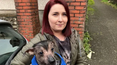 bbc Katie Roberts on the street holding her dog