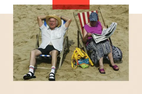 Getty Images A couple soak up the sun on Blackpool beach on 6 August 2003 in Blackpool, England.
