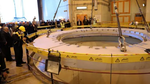 WANA via Reuters Members of the media and officials tour the reactor at Arak Nuclear Power Plant, Iran (23 December 2019)