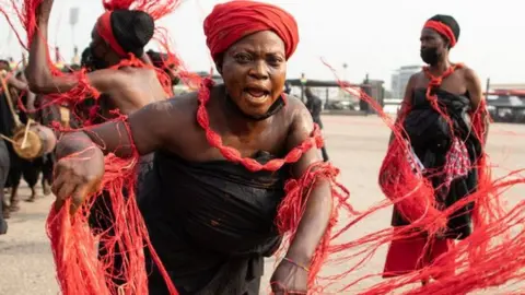 A traditional group performs the final funeral rites of former Ghana President Jerry John Rawlings in Accra, Ghana, on January 27, 2021. - Former Ghana President Jerry John Rawlings died in November 2020 at the age of 73 and his funeral was initially scheduled for December 23, 2020 but was postponed, due to what the foreign ministry called "unforeseen circumstances".