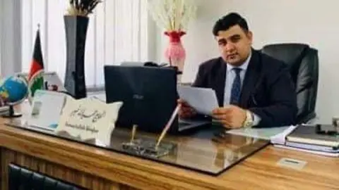 Hamidullah Khyber sat in an office, where he was a translator for the Ministry of Defence in Afghanistan.