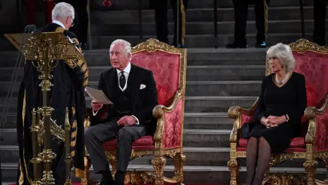 PA Media King Charles was accompanied by his wife the Queen Consort while he addressed MPs and peers