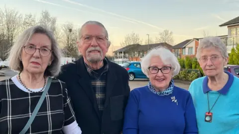 Residents of Lark Hill Retirement Village stood on the grounds of the village.