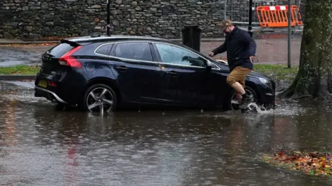 PA Media Flooded car park in Keswick