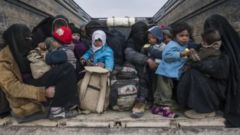 AFP/Getty Images Woman and children who fled the Islamic State (IS) group"s embattled holdout of Baghouz on February 14, 2019