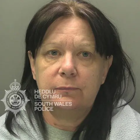 CPS Mugshot of Catherine Francis, who has long dark hair and is wearing a grey top 