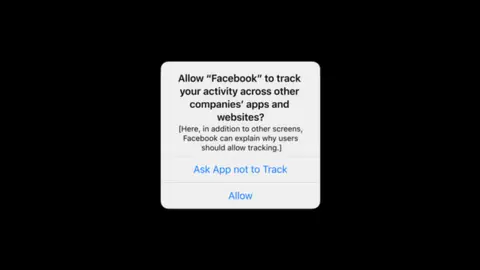 Apple A screenshot showing an iOS message asking users to verify that they permit Facebook to track their data when using apps owned by the firm