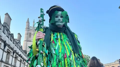A man dressed in green man costume in Oxford