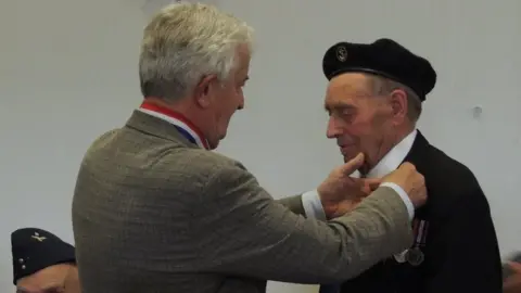 Tyler family Veteran John Tyler receiving a medal for his time served during World War Two