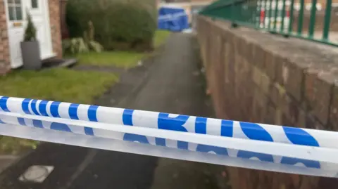 Police tape across a street scene 