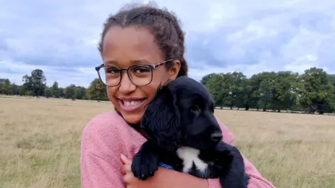 Wellchild Anya cuddling a dog