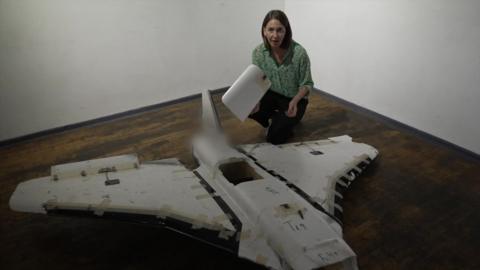 Sarah Rainsford stands next to a Russian Gerbera drone