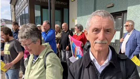 BBC Toni Schiavone with protestors outside the Aberystwyth Justice centre