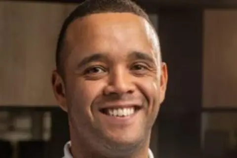 Headshot of Michael Phipps, smiling into the camera