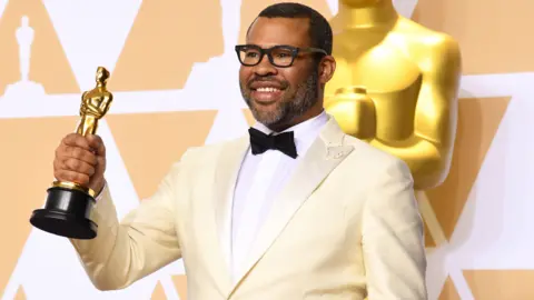 Getty Images Jordan Peele with his Oscar for best original screenplay at the Academy Awards in 2018