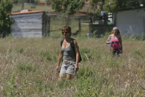 Getty Images British tourists search for Madeleine McCann in wasteland on 8 May 2007 outside the Algarve resort of Praia da Luz in Portugal